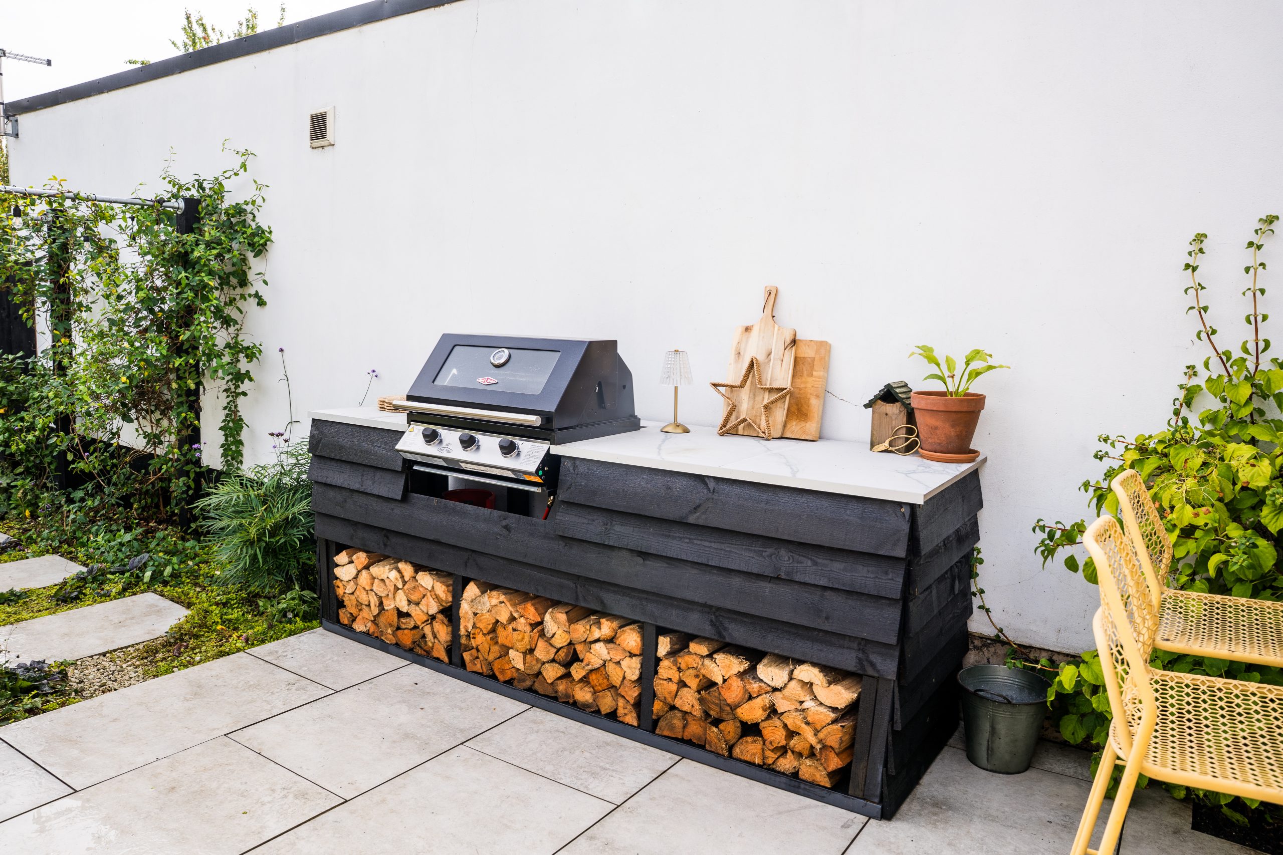 outdoor kitchen with wood log burner storage